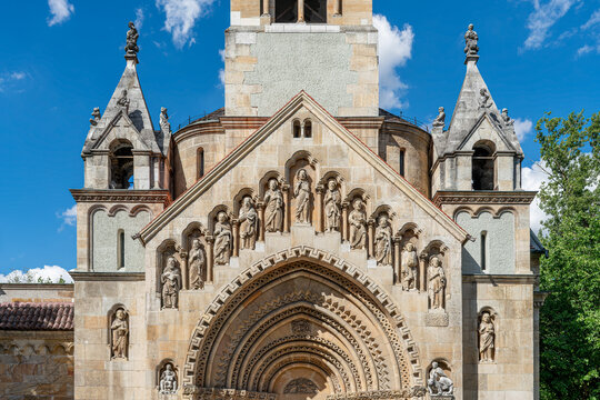 Full facade of the Jaki Chapel with twin bell towers and a carved romanesque portal in Budapest, Hungary