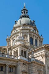 Green copper dome and lantern of St Stephen's Basilica rising above statues and balustrades in central Budapest, Hungary © Guillaume Angleraud
