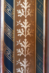 Close-up of gilded tree motif pilaster panels flanked by blue stenciled columns in the Hungarian Parliament © Guillaume Angleraud