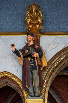 Polychrome statue of a photographer holding a vintage camera in the Hungarian Parliament Building in Budapest