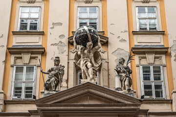 Atlas statue supporting a globe and flanked by statues of War and Peace above a doorway of the Town Hall in Budapest, Hungary © Guillaume Angleraud
