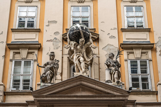 Atlas statue supporting a globe and flanked by statues of War and Peace above a doorway of the Town Hall in Budapest, Hungary