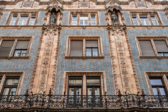 Blue glazed tile facade of Thonet House with a wrought iron balcony and statues in niches on Vaci utca in Budapest, Hungary