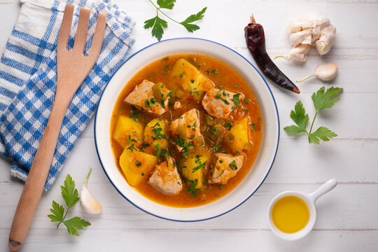 Traditional Basque tuna stew with potatoes served on a festive holiday table setting. Marmitako de at&uacute;n.