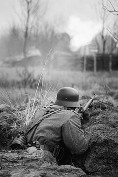 German Wehrmacht Infantry Soldiers In World War II Hidden Sitting With Rifles Weapons In An Ambush In Trench