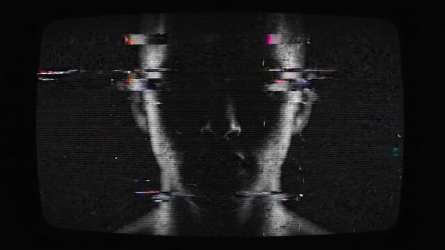 Man with dark face in black room with glitch digital error on screen.