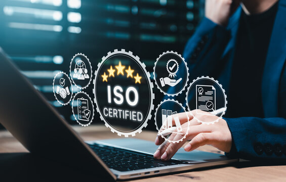 ISO certification and quality management concept. Businesswoman using laptop with icons for compliance, audit, standards, documentation, assurance, process control, accreditation, business excellence