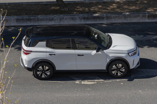 White crossover suv car driving on urban street