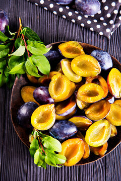 Plums on wooden background