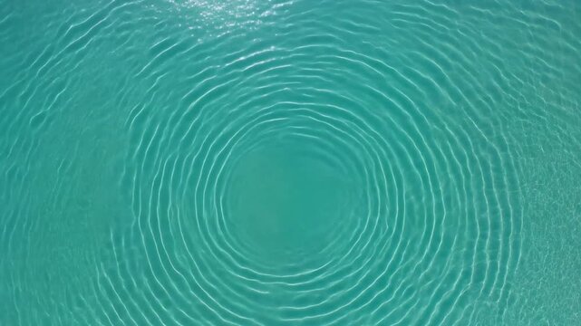 Circular Ripples on Turquoise Water Surface - Aerial View