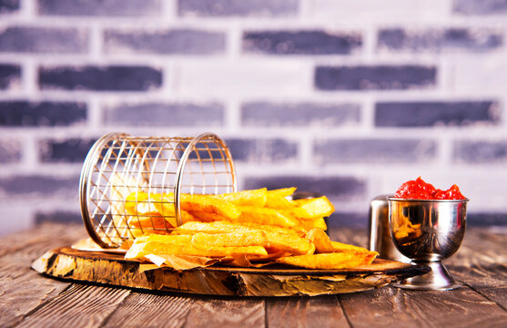 Crisp golden brown curly fried potato with rich red tomato dipping sauce close-up for snack or appetizer
