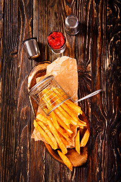 Crisp golden brown curly fried potato with rich red tomato dipping sauce close-up for snack or appetizer