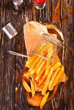 Crisp golden brown curly fried potato with rich red tomato dipping sauce close-up for snack or appetizer