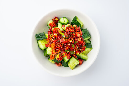 A plate of cold cucumber salad with a sour and spicy dressing