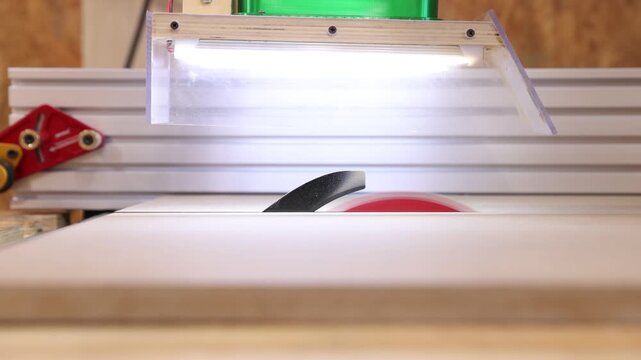 Closeup of a circular saw blade cutting wood in a workshop