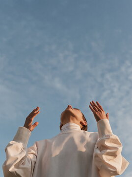 Close-Up View of a Person's Hands and Chest Engaged in Meditation with Soft Natural Light Enhancing the Serene Atmosphere