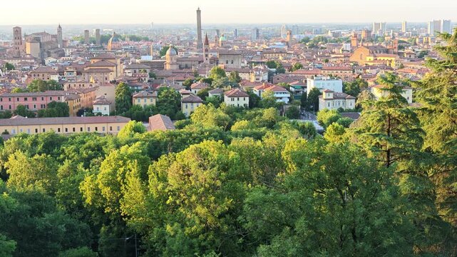 Bologna cityscape showcasing the historic downtown with its ancient buildings, prominent churches, and the iconic Asinelli and Garisenda towers rising above the medieval rooftops in Italy