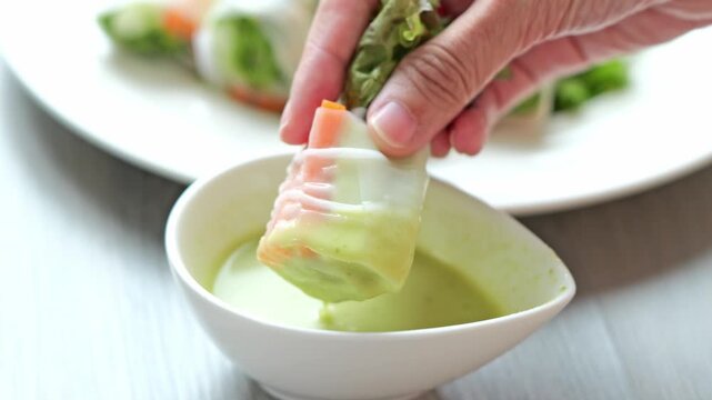 Fresh Spring Roll Dipping Sauce Hand Held Appetizer with Vegetables Close Up View