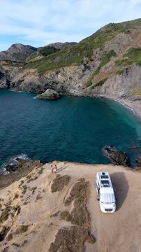 Discover the stunning beauty of La Frana Beach in Sardinia, Italy. Relax on the sandy shores, enjoying the crystal-clear waters and picturesque coastline under the sun in a camper van