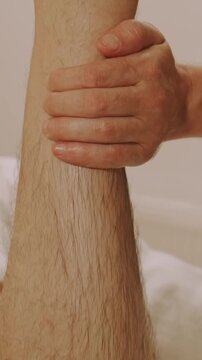 warm view, hand gripping forearm, fingers pressing skin showing indentation, diffused light reveals hair pores