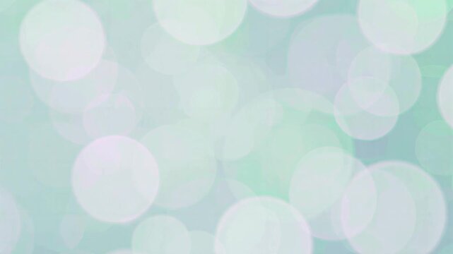 Soft glowing teal bokeh particles floating in continuous gentle motion for a dreamy background video footage