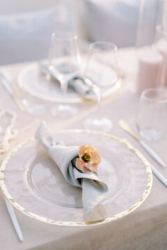 Elegant wedding dinner table setting with floral napkin