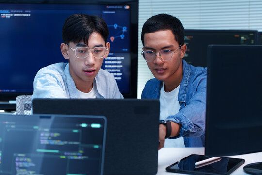 Programmer Developers Collaborating on AI Software Code