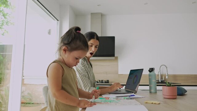 Working mother juggling career and childcare at home