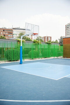 vertical Empty outdoor basketball court in urban park
