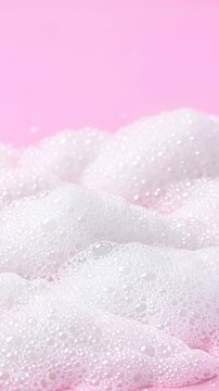 Close-up of Thick White Foam on a Soft Pink Background