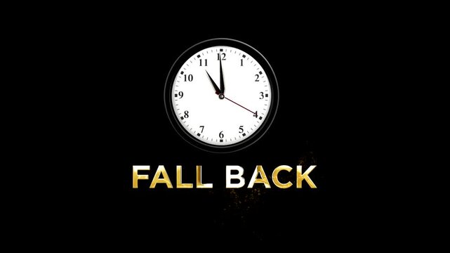 Analog wall clock showing the time with golden glowing fall back text effect