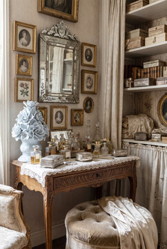 Delicate romantic dressing corner with venetian mirror, portrait miniatures and tufted ottoman