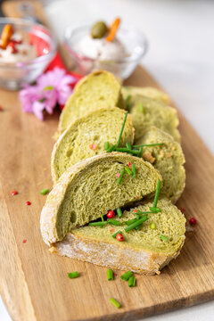 Fresh sliced green bread herbs chives served on wooden board show rustic texture homemade bakery style. Savory food scene with seasoning craft beer pairing gourmet appetizer, natural cuisine closeup