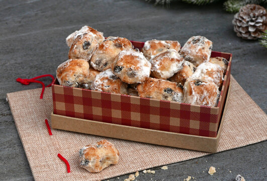 Festive stollen bites in a red-and-white checkered gift box against a rustic background.