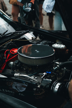 Vintage American Muscle Car V8 Engine with Big Carburetor Under Hood

