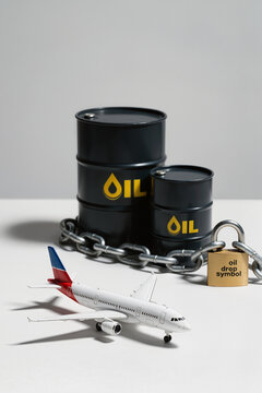 Passenger airplane model beside locked oil barrels symbolizes restricted petroleum supply, aviation fuel dependence, and energy security.
