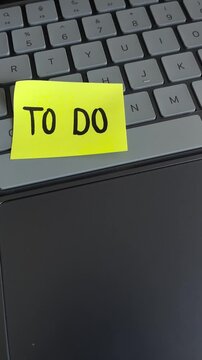 Digital to do list sticky note on laptop keyboard