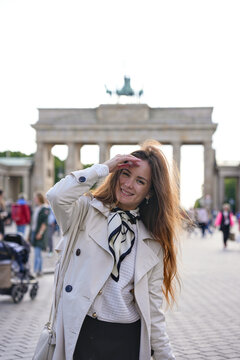 Smiling woman posing before Brandenburg Gate in Berlin