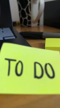 To do list sticky note on desk with laptop and pen
