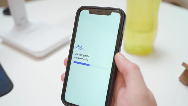 Checking visa requirements on smartphone with no visa required result. Travel app confirmation screen with green progress bar