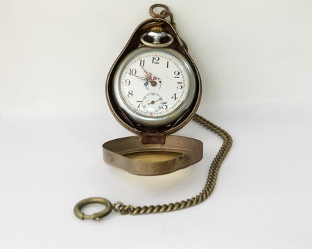 Vintage pocket watch in a protective brass case with attached chain, isolated on a white background. Perfect classic timekeeper for collectors, displaying intricate mechanical details.