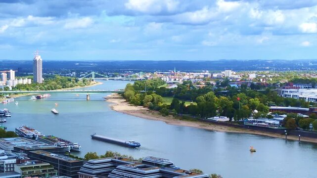 panoramic view of river rhine in cologne with cargo ships and modern city skyline, logistics, transport, waterway, navigation, maritime trade, industrial port