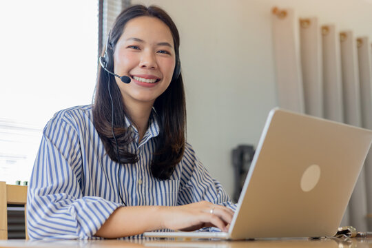 close up call center employee woman smile with happy while working on desktop to check about task and reply email from customer in office room for one stop service and communication technology concept