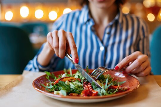 The Salad Plate with Fresh Greens and Tomatoes in a Lively Restaurant