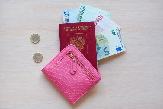 Russian passport with euro banknotes inside a pink leather wallet