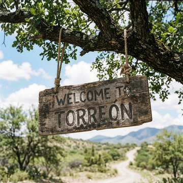 Rustic Welcome To Torreon Sign Hanging From Tree Branch Amidst Scenic Landscape