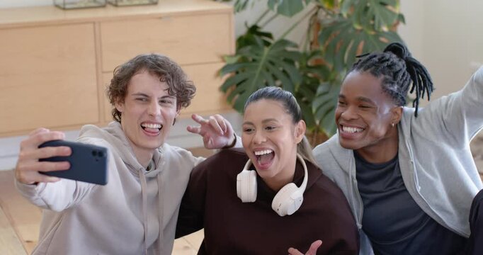 Diverse friends starting selfie, left extending smartphone, posing, laughing, capturing memory