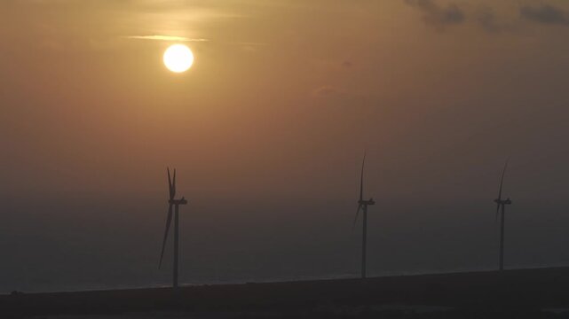 wind turbines at sunset