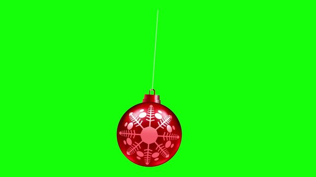Red Christmas bauble with snowflake decoration gently swinging on a green screen, for holiday video compositing, promotions and festive motion graphics.