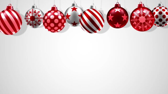 Festive Christmas motion background of red and white baubles with stripes, stars, snowflakes and polka dots on a white backdrop for promotional or advertisement.